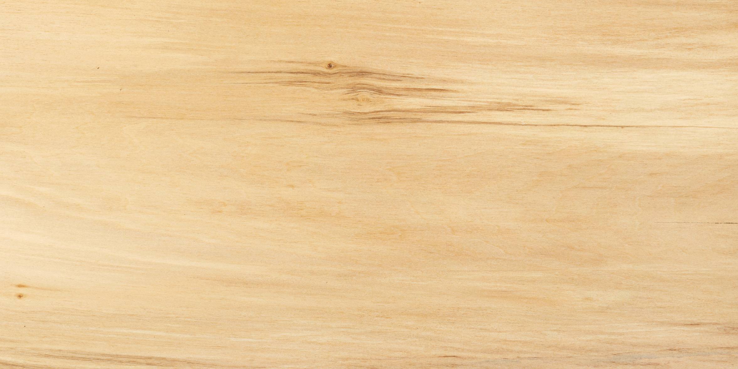 Close-up of a lime wood board surface with a light brown color and visible grain pattern.