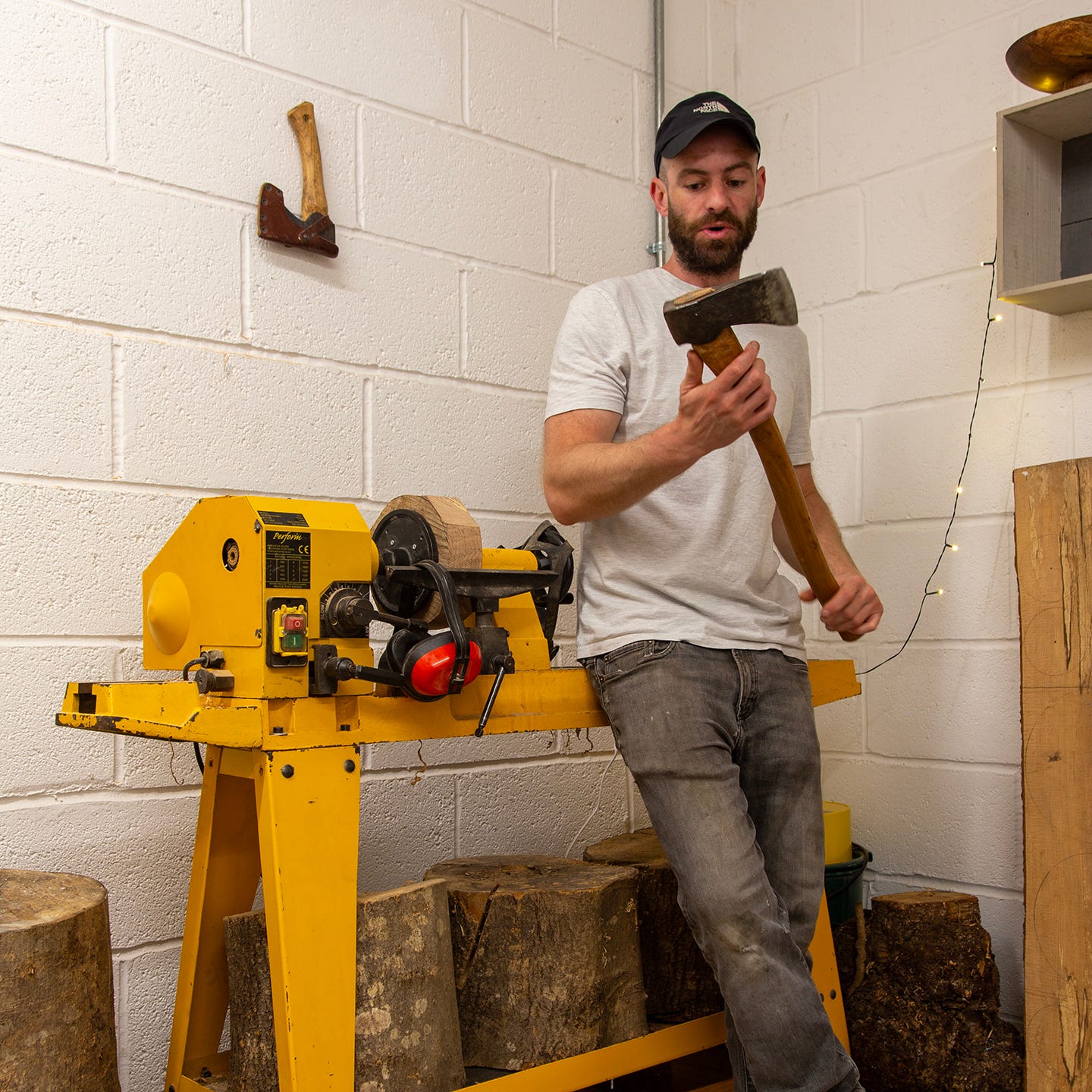 A woodworker holding an axe. Mike Groves of Skapa Woodturning
